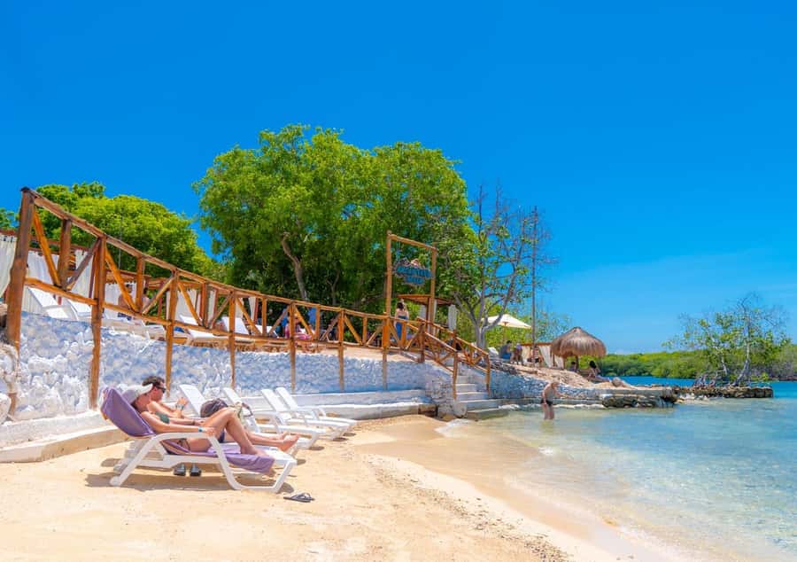 Cartagena: Rosario Islands Day Tour with Snorkel & Lunch - Isla Grande at Encantada Beach Club: beach chairs, clear water, and a real break